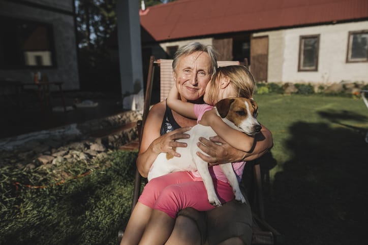Smiling grandmother with child and dog